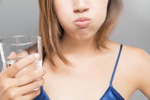 Woman trying toothache remedies